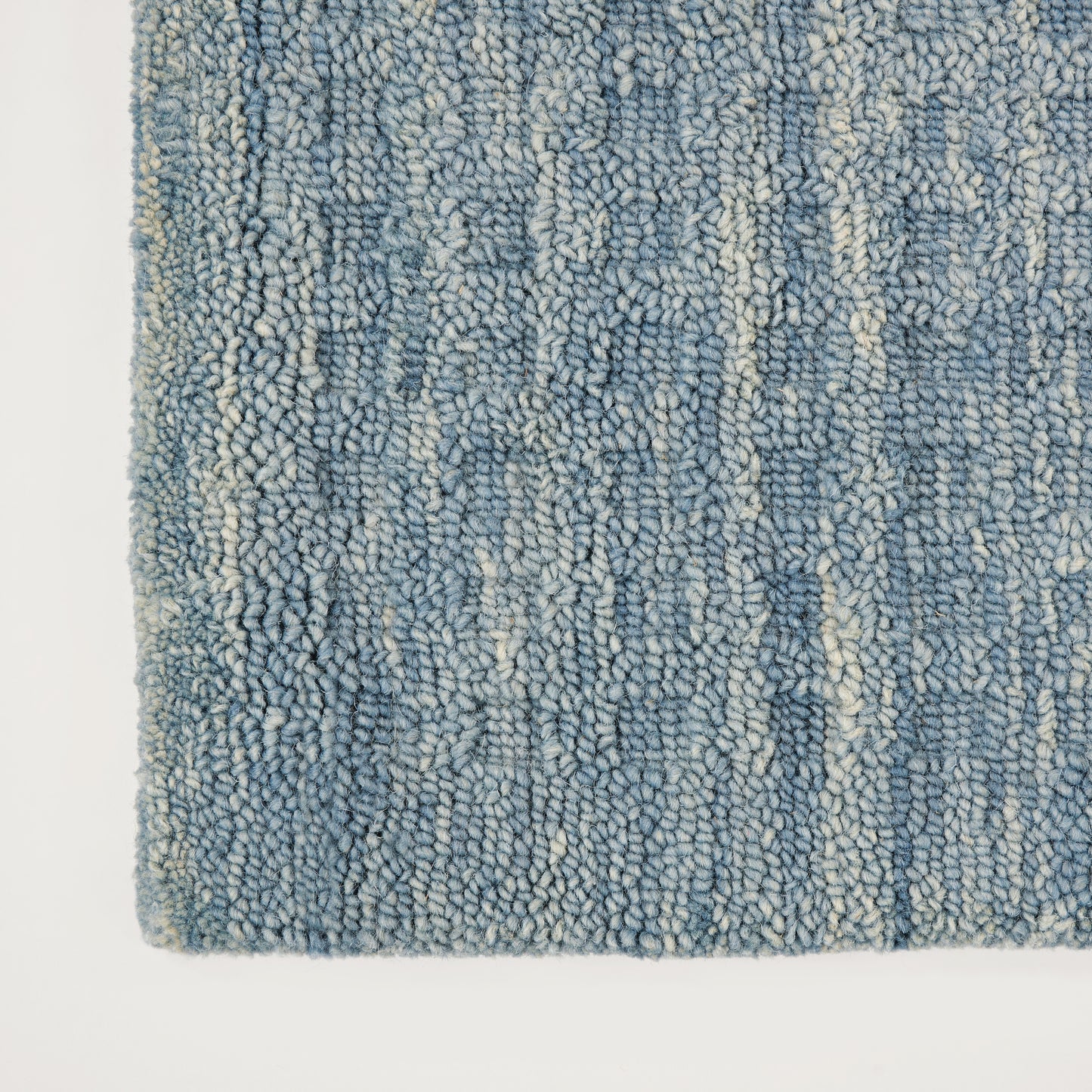 Blue loop-pile runner rug with plush shaggy texture, mixed indigo and light blues with cream specks; long rectangular 8' runner.