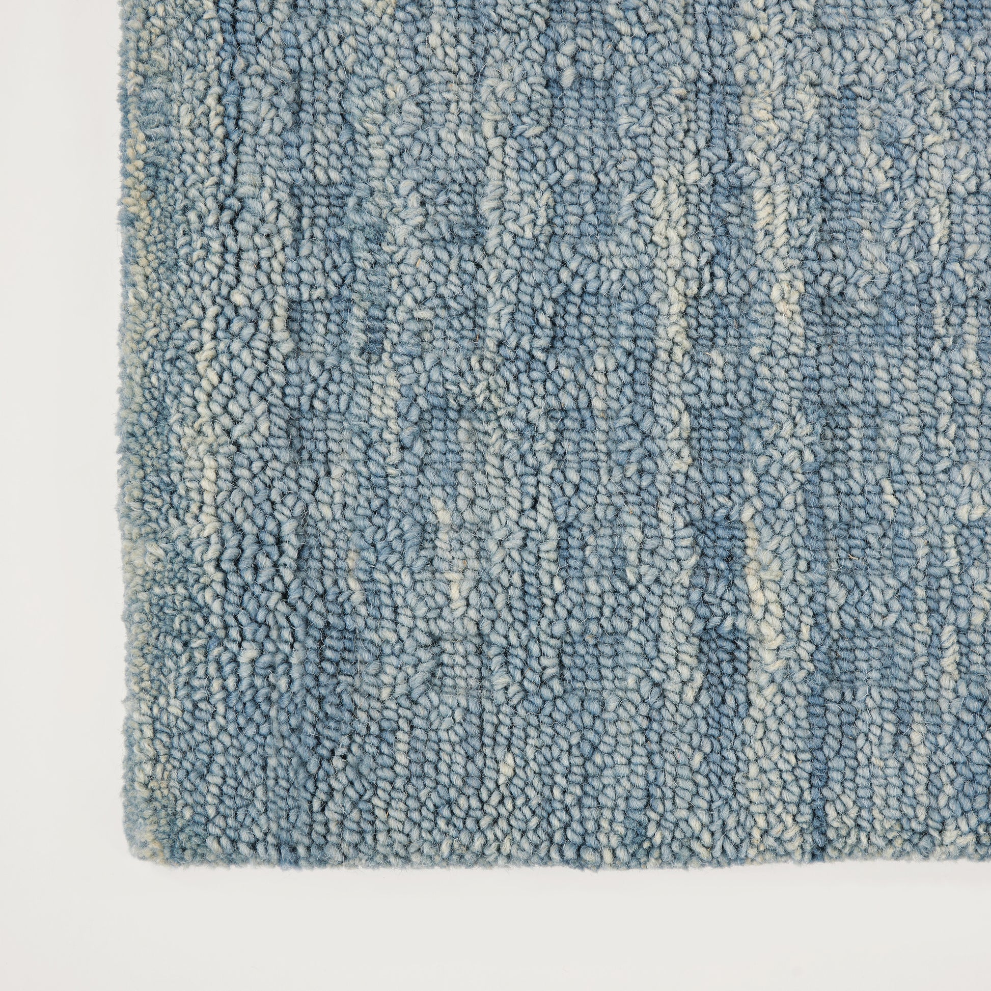 Blue loop-pile runner rug with plush shaggy texture, mixed indigo and light blues with cream specks; long rectangular 8' runner.