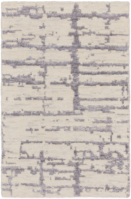 Cream shag rug with lavender-gray abstract lines and plush texture.