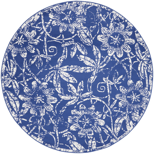 Round blue ceramic plate with white floral pattern; decorative blue-and-white charger.