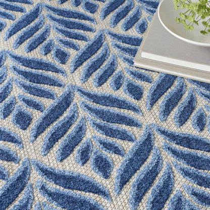 Blue shag area rug with beige background and botanical leaf pattern; plush pile for living room decor.