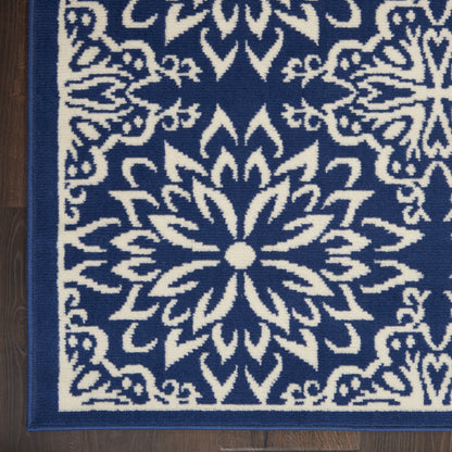 Blue and white woven rug with a bold central floral mandala pattern and decorative border.