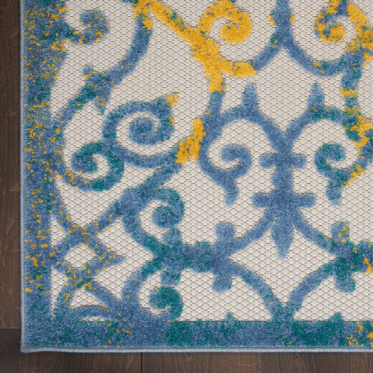 Damask-style rug in blue, teal and yellow with scrolling motifs; decorative woven textile.