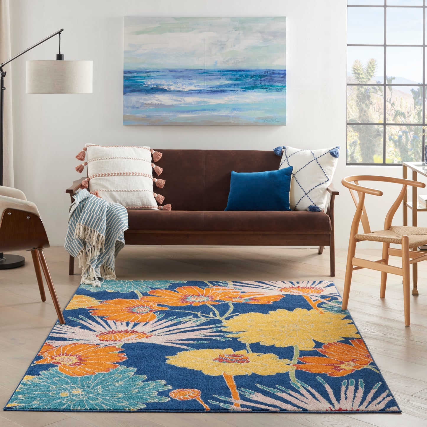 Rectangular area rug with bright floral pattern in orange, yellow, blue and teal; modern living room.