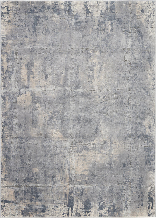 Abstract distressed gray-blue and beige area rug with soft vintage tones and washed texture.