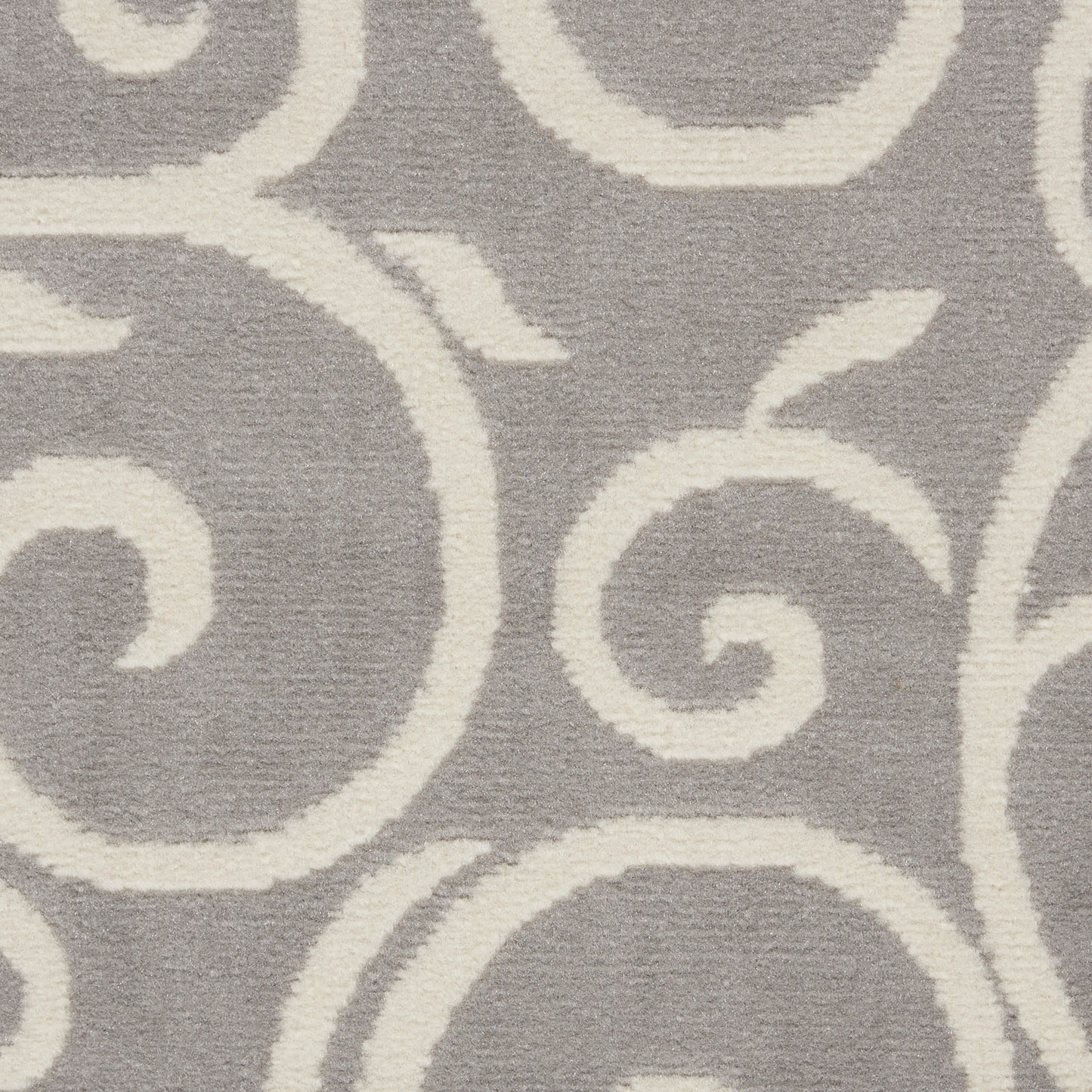 Gray rug with cream scrolling arabesque design.