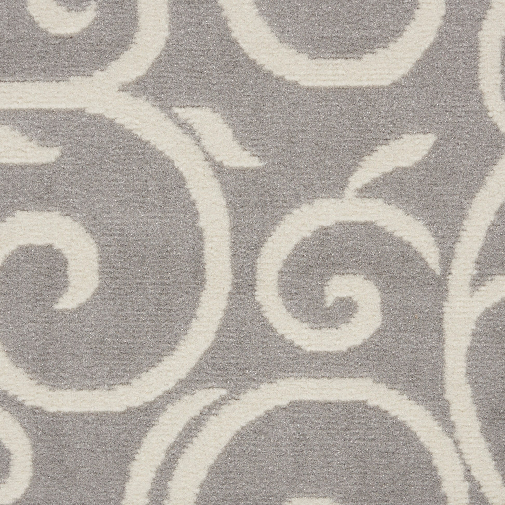 Gray rug with cream scrolling arabesque design.