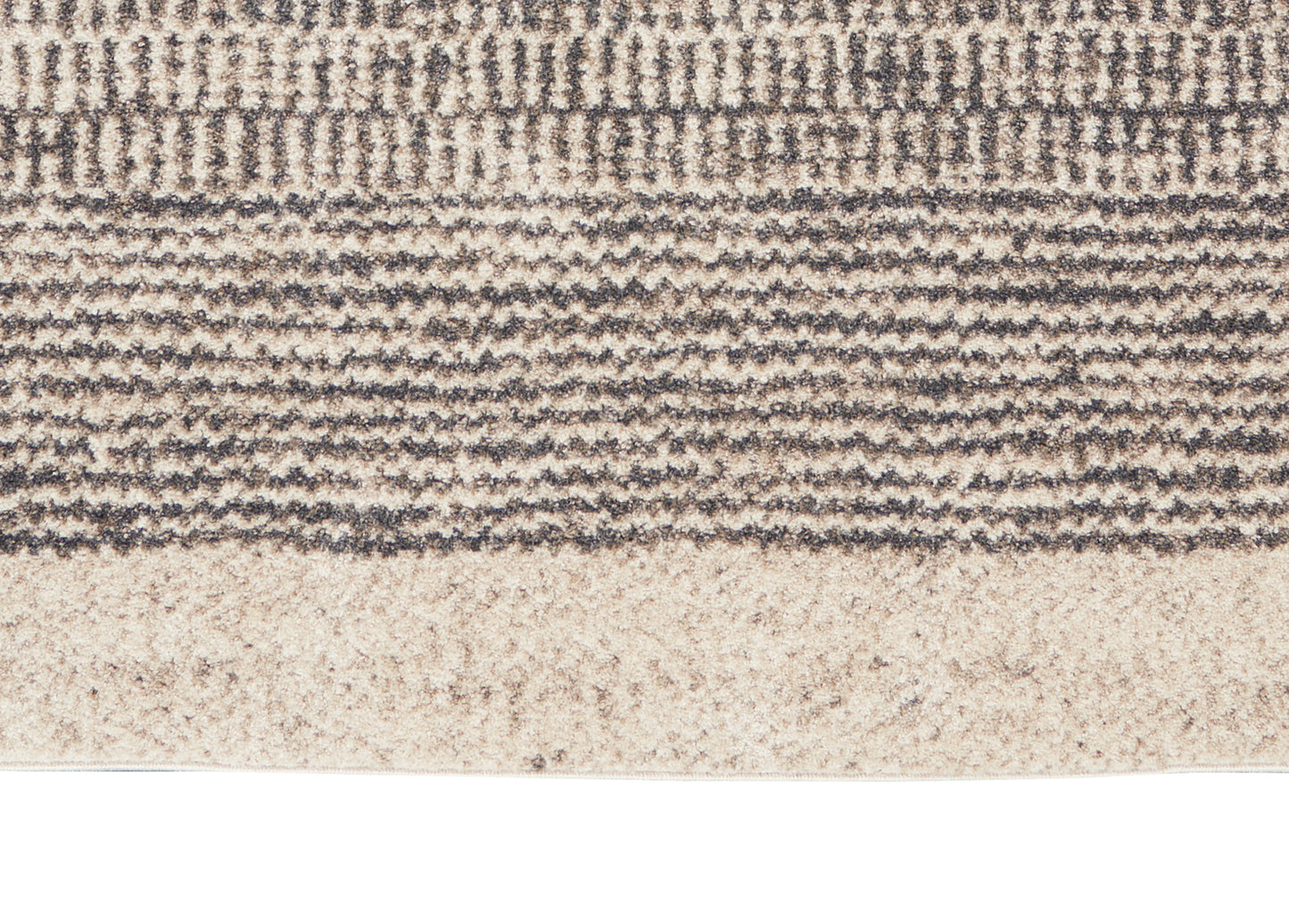 Close-up of beige and taupe woven rug with textured horizontal bands and subtle wave pattern.