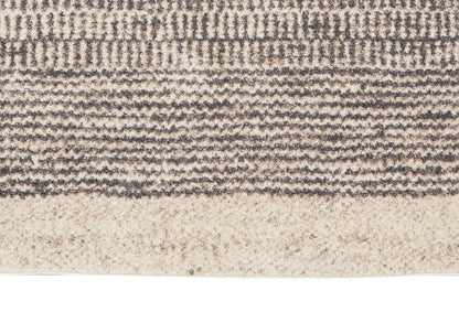 Close-up of beige and taupe woven rug with textured horizontal bands and subtle wave pattern.