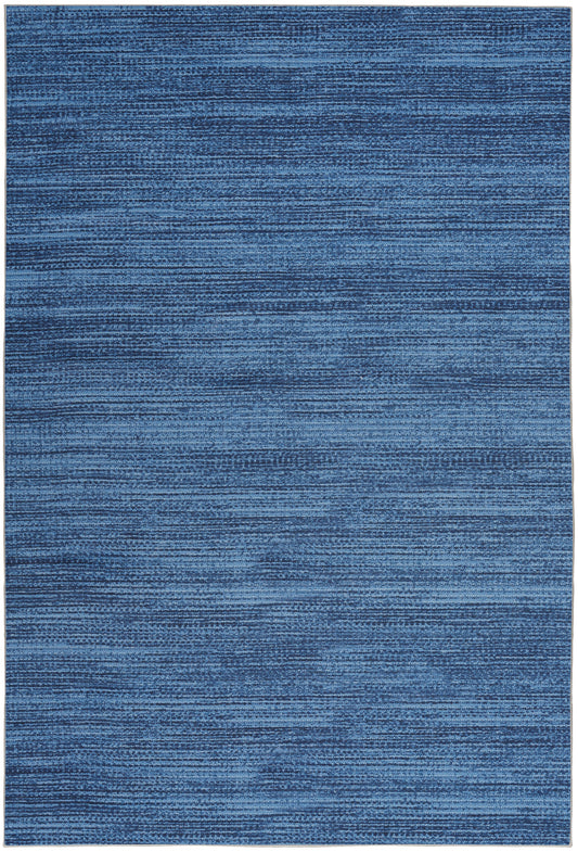 Rectangular blue woven rug with variegated indigo tones and subtle horizontal stripes.