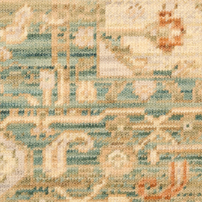 Woven area rug with teal, cream and blue geometric motifs in a vintage tapestry style.