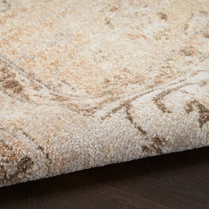 Beige cream shag rug with a subtle abstract pattern, thick plush pile, folded edge on dark wood floor.