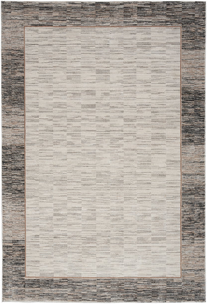 Rectangular beige textured rug with a thin copper-brown inner border and a dark charcoal outer border.