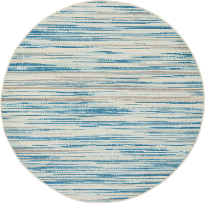 Round rug featuring blue and cream brushstroke stripes in an abstract, coastal-style pattern.