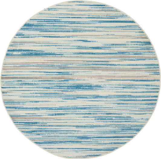 Round rug featuring blue and cream brushstroke stripes in an abstract, coastal-style pattern.