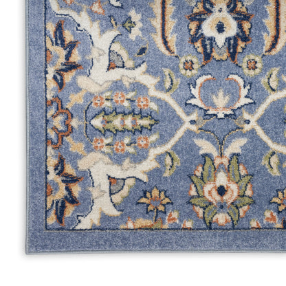 Blue oriental-style area rug with ivory floral motifs, orange accents, and decorative border.