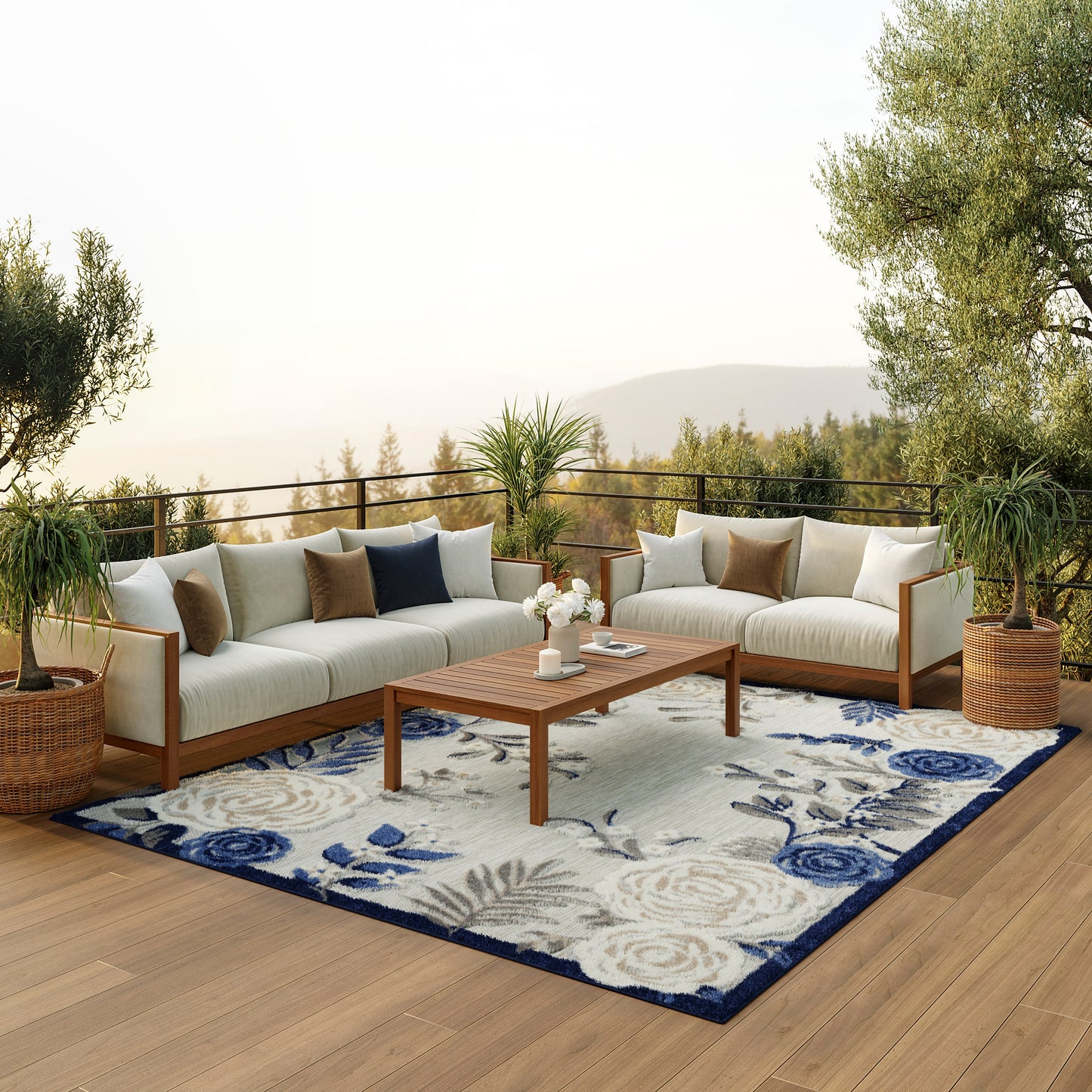 Contemporary rug 8' x 11' with a floral pattern, shown on a patio with beige-cushioned seating, a coffee table and potted plants.