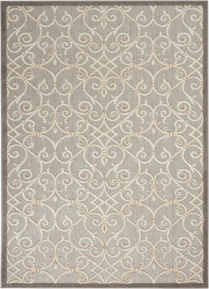 Gray area rug with a cream scrolling lattice pattern and subtle beige border, soft textured floor decor.
