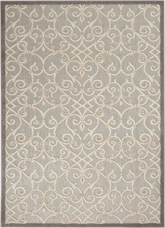 Gray area rug with a cream scrolling lattice pattern and subtle beige border, soft textured floor decor.