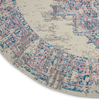 Round vintage-style rug with distressed pink, blue & beige medallion pattern & woven texture.