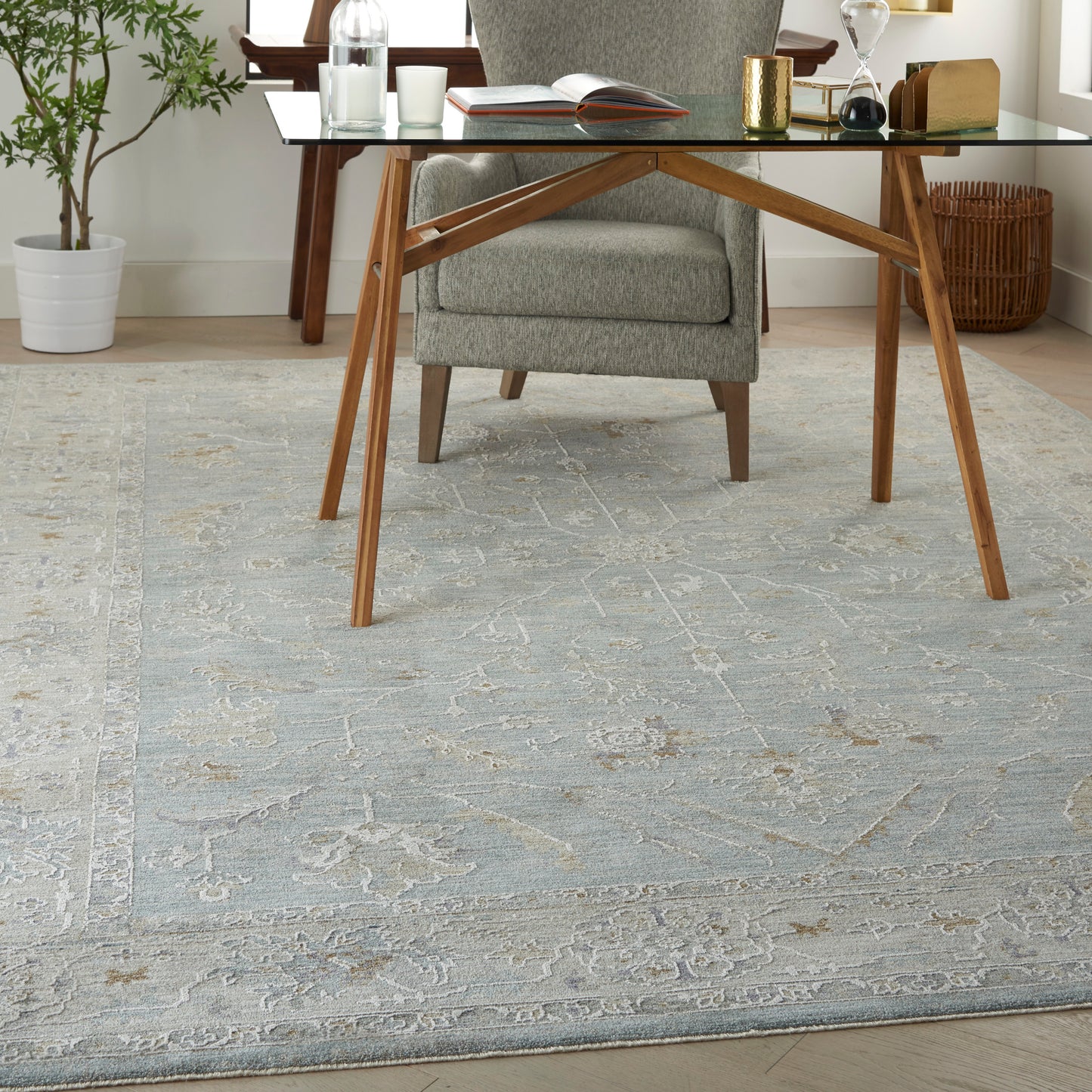 Blue-gray ornate area rug in a room setting.