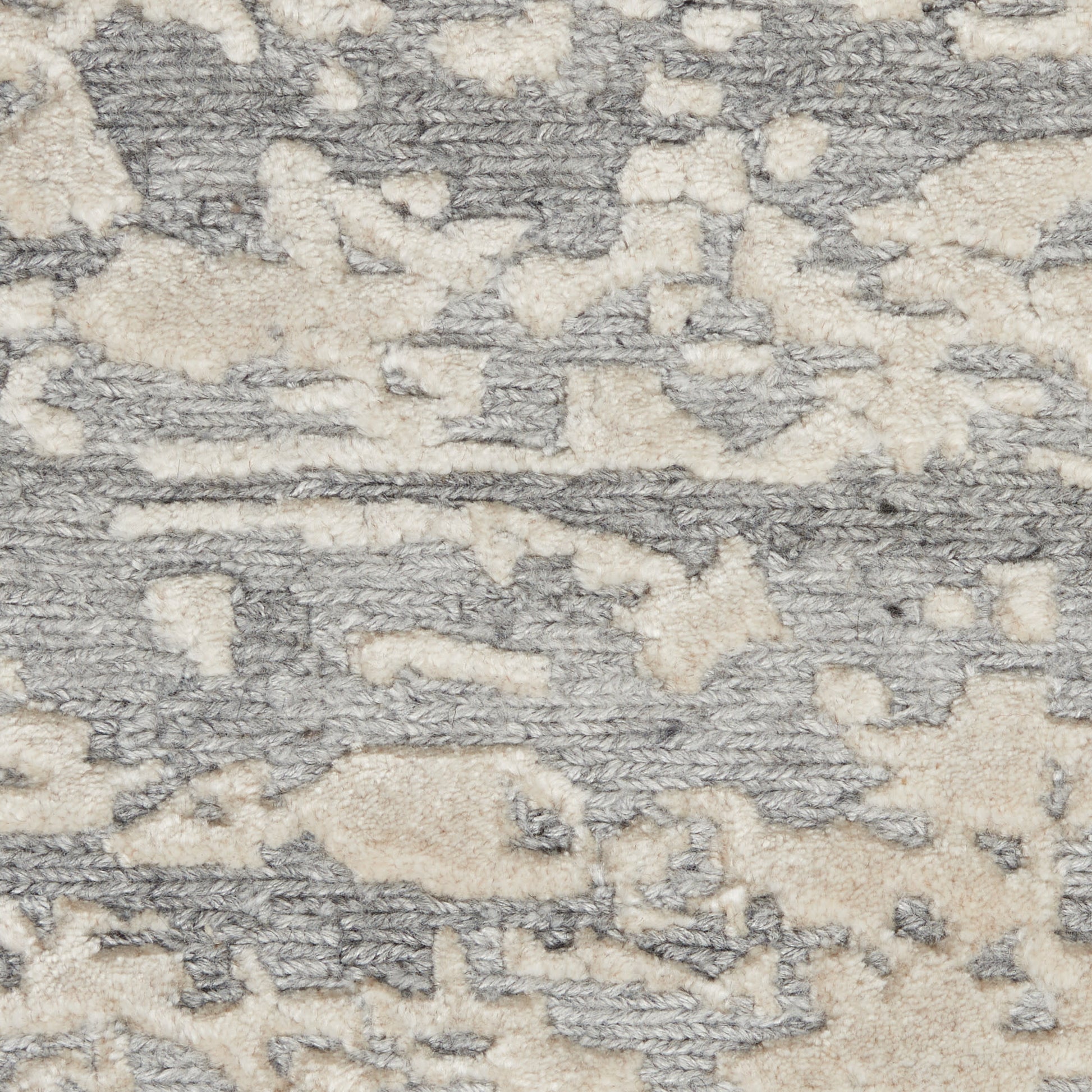 Gray and cream shag rug with an abstract camo pattern and plush tufted pile.