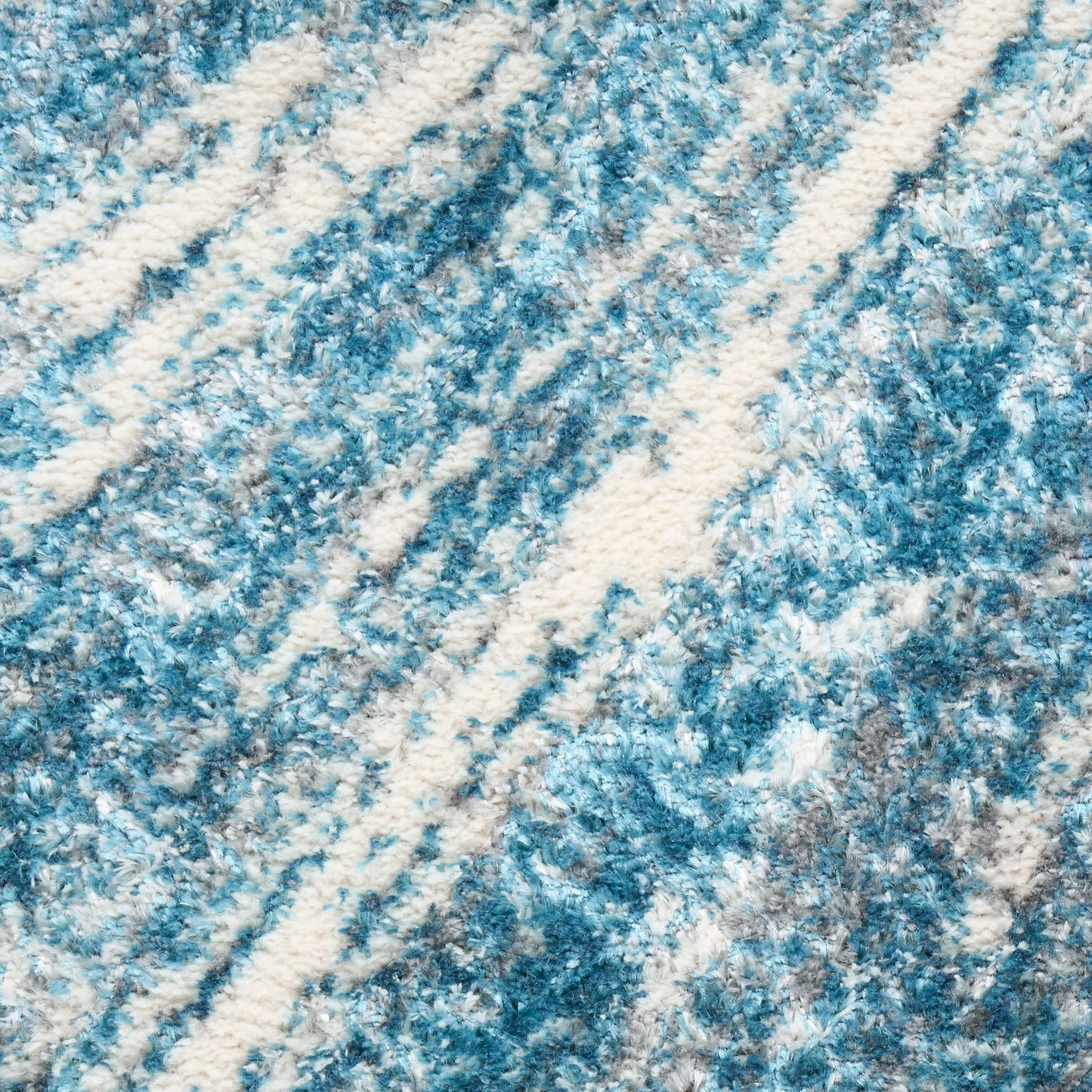 Blue and white textured rug with diagonal stripe pattern and plush pile.
