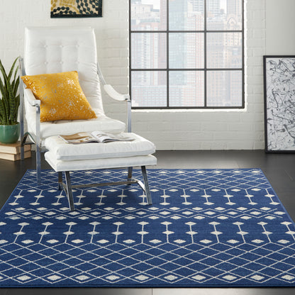 Blue geometric rug in a white brick loft with a grid window.