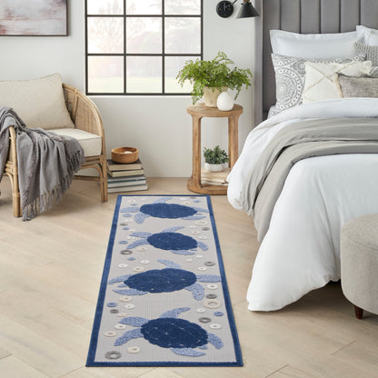 Woven runner rug featuring large navy blue circles on pale grey with a navy border.
