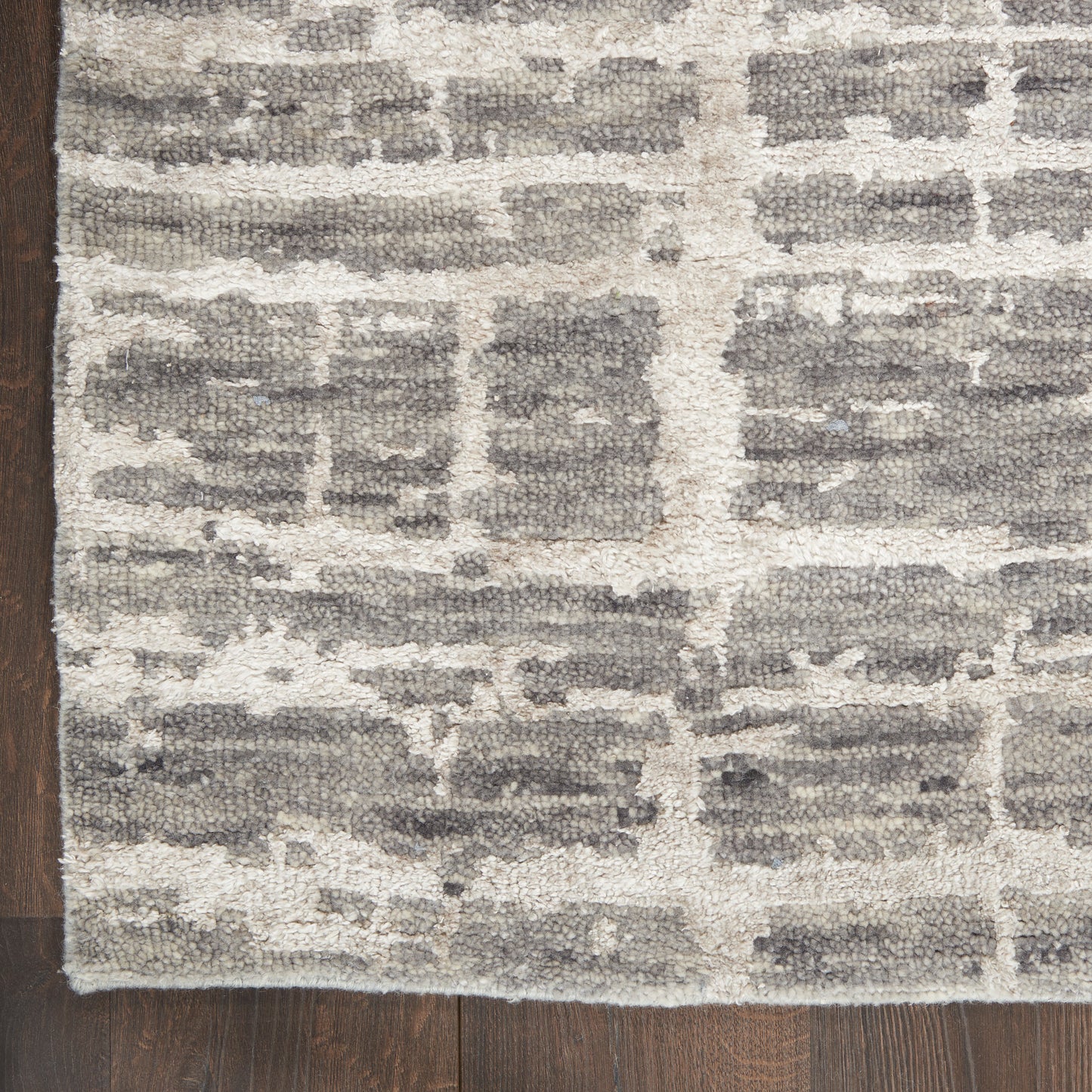 Rectangular plush-pile rug in gray and ivory brick-pattern, modern geometric design for living spaces.