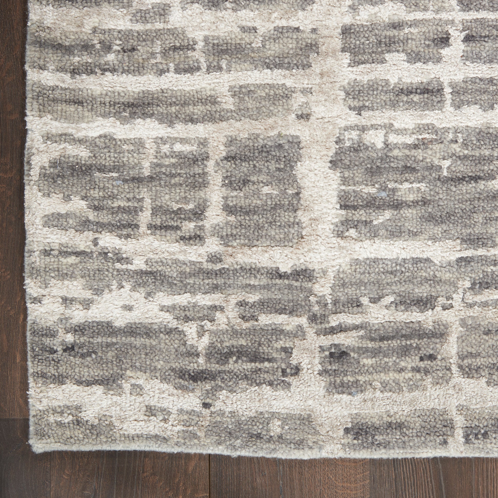 Rectangular plush-pile rug in gray and ivory brick-pattern, modern geometric design for living spaces.
