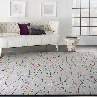 Tufted white sofa, purple pillow, gray rug with pink, gold, and black wavy lines; white brick wall, framed art, large window.