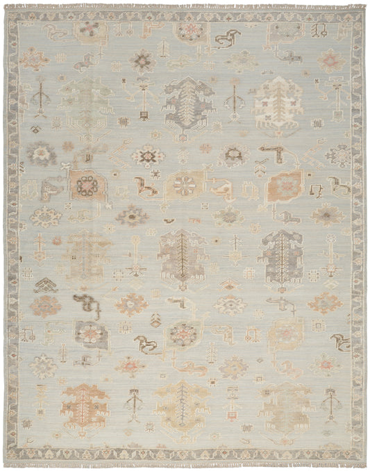 Pastel blue antique-style area rug featuring faded ivory, beige and peach geometric floral motifs and a decorative border.