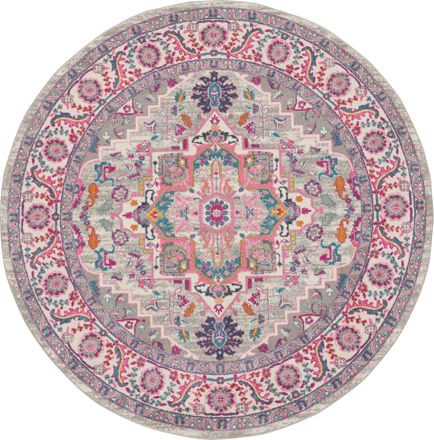 Round oriental rug in pink, teal and cream with central medallion and floral border; vintage-inspired decor.