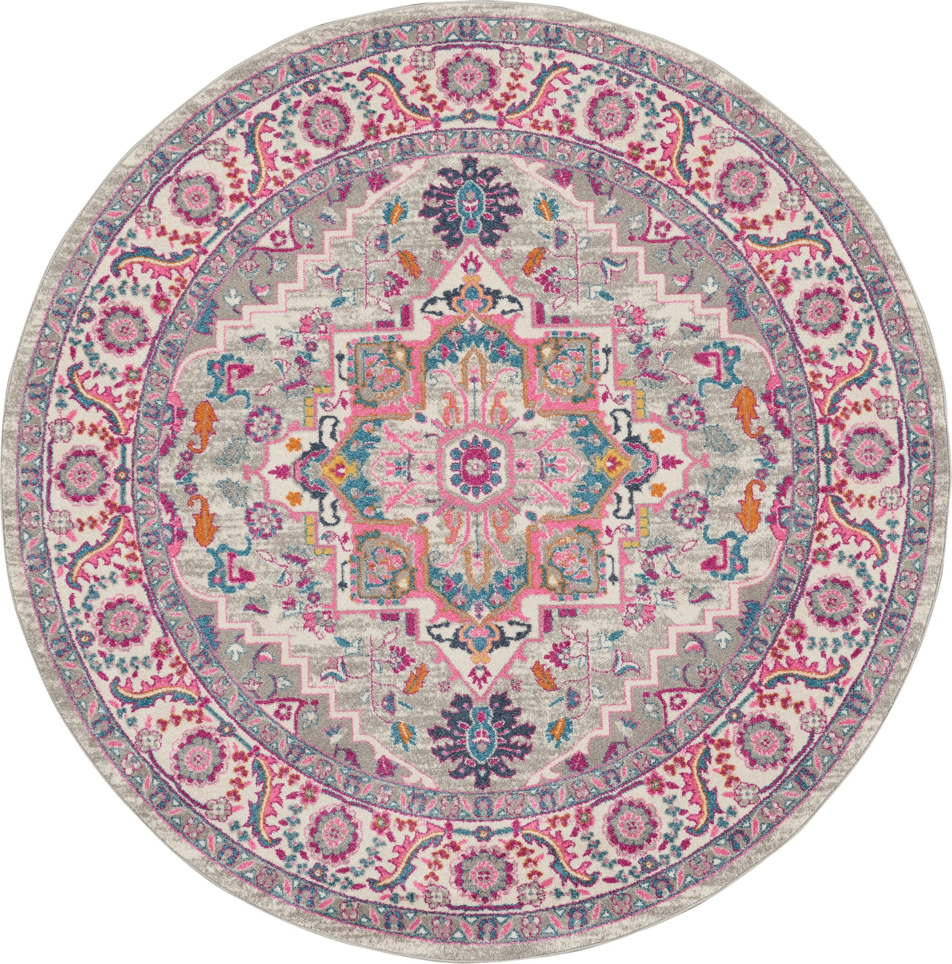 Round oriental rug in pink, teal and cream with central medallion and floral border; vintage-inspired decor.