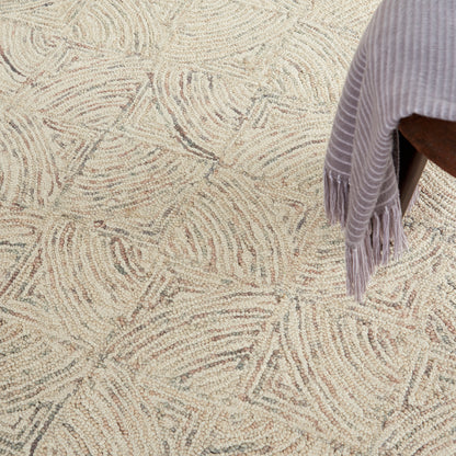 Textured cream rug with beige abstract swirl pattern; lavender fringed throw draped over a chair.