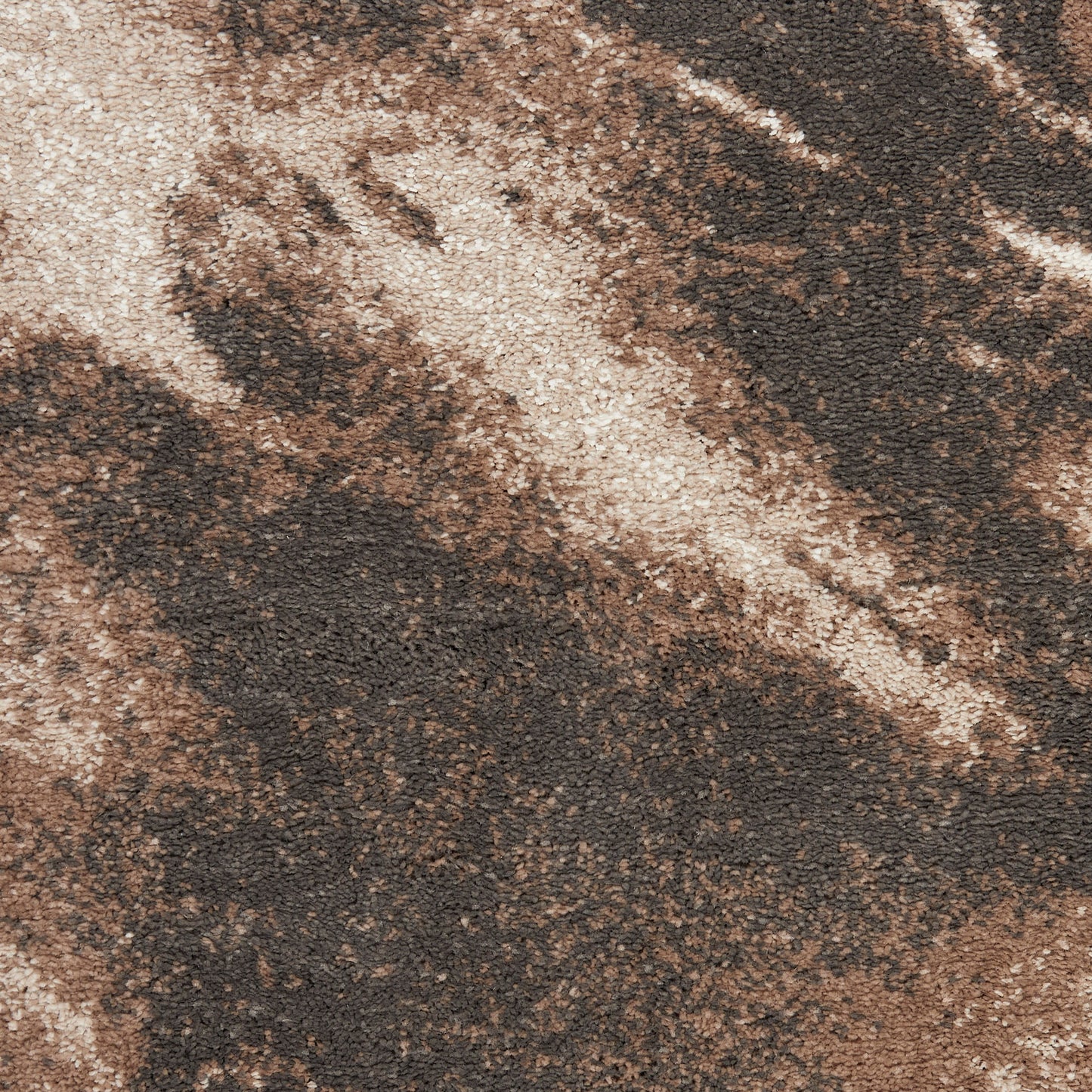 Close-up of a brown and beige abstract patterned rug with shaggy plush pile.