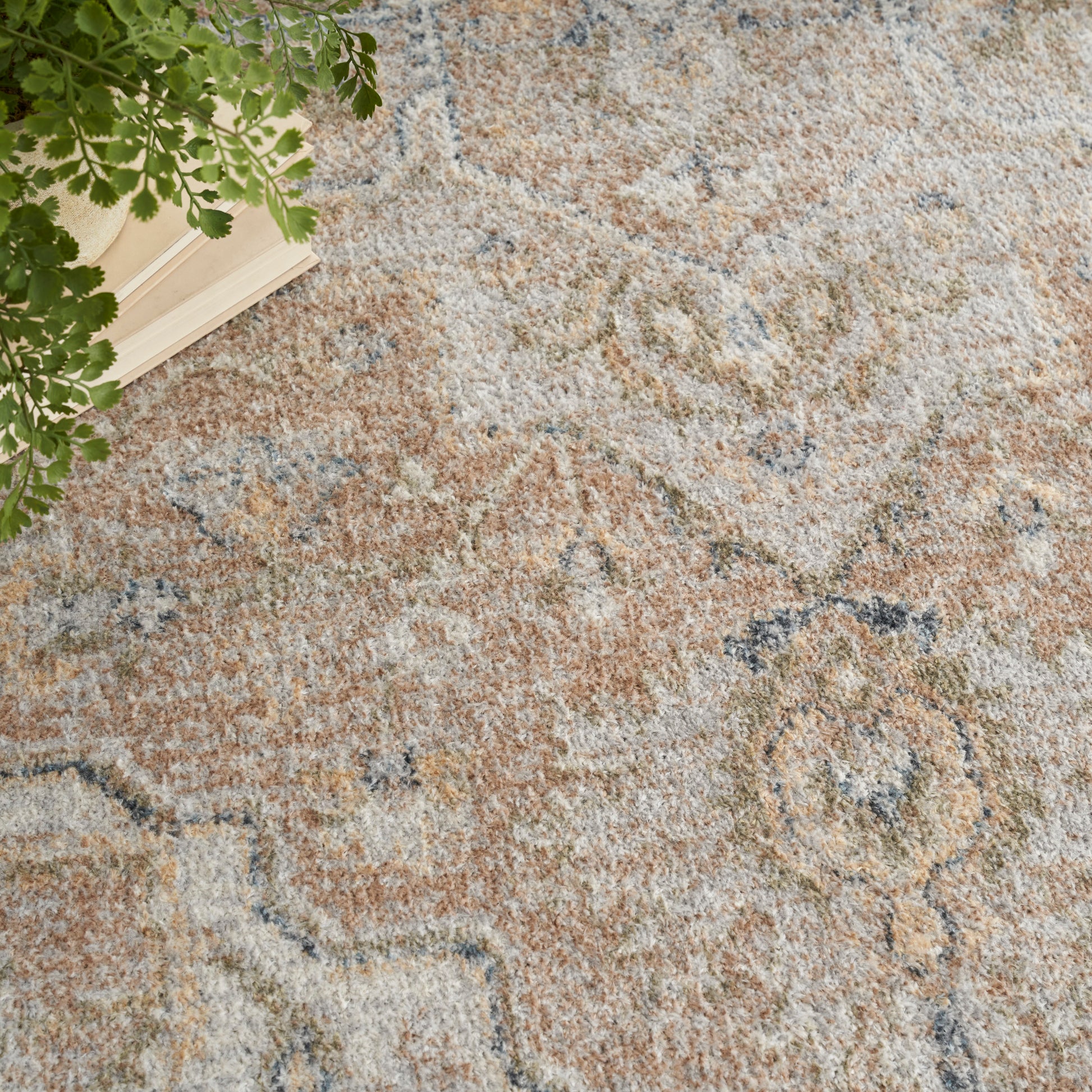 Neutral-toned oriental area rug with faded beige, taupe and blue motifs; plush textured pile.