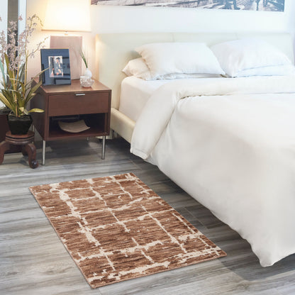 White bedding on a modern bed with dark wood nightstand, lamp, plant, framed photo; brown geometric rug on gray wood floor.