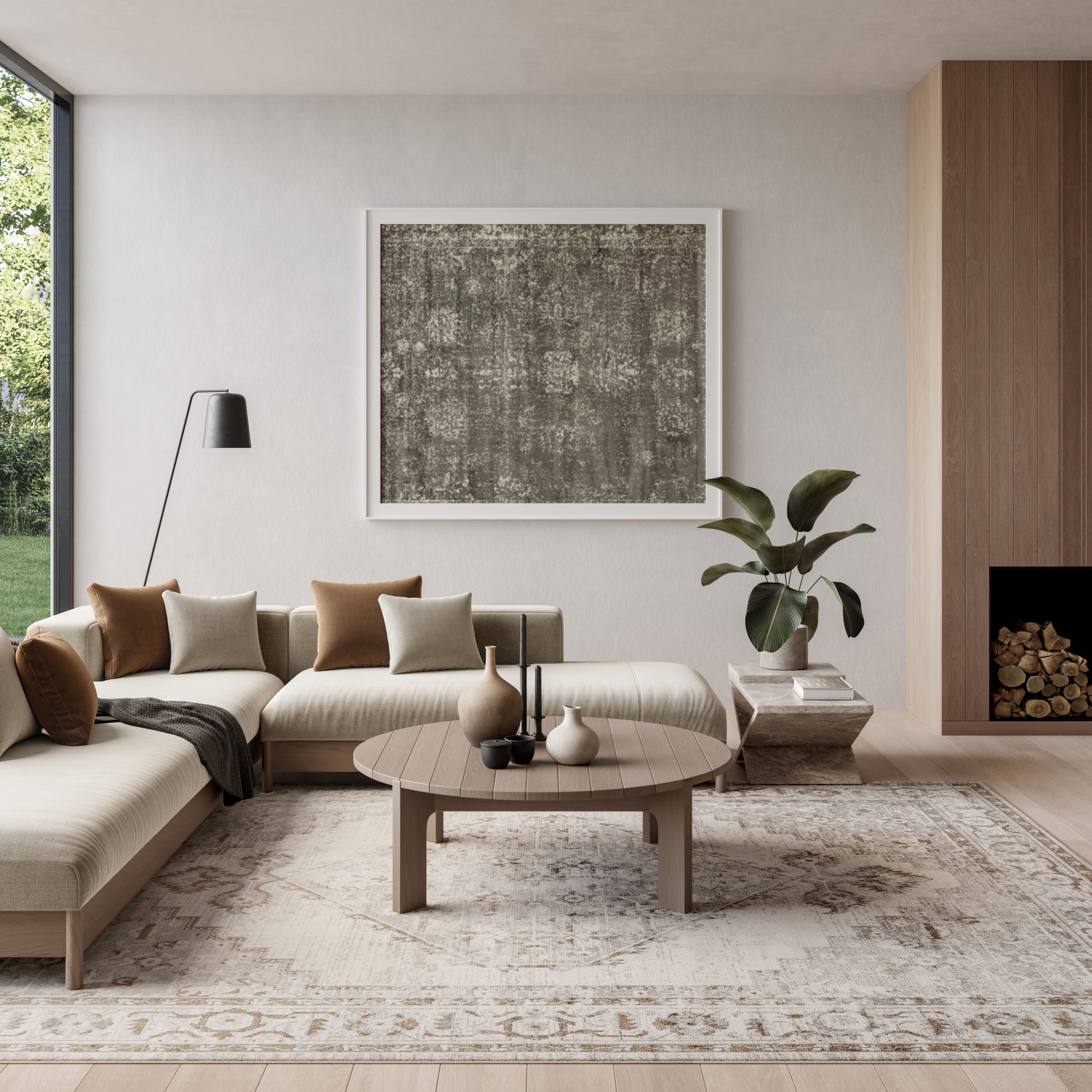 Neutral-toned living room with a vintage 8' x 10' rug, beige sectional, round wood coffee table, abstract art, tall floor lamp, and a plant.