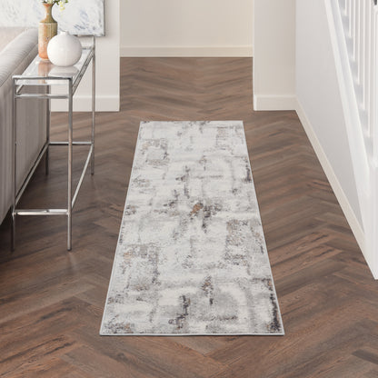 Long neutral runner rug with an abstract gray pattern in a modern hallway beside a glass console.