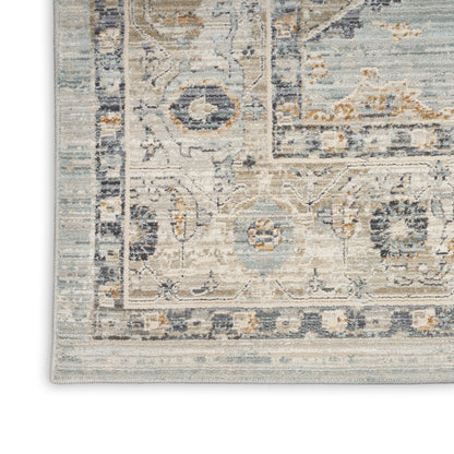 Distressed vintage-style area rug with floral motifs in ivory, blue, beige and gray; rectangular with ornate border.