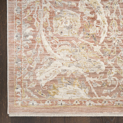 Soft pink distressed oriental runner rug with ivory floral motifs and subtle gold accents, fringed edge on a wooden floor.