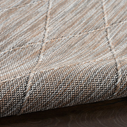 Beige patchwork woven rug with textured looped weave, stitched seams and soft cotton-blend fibers, 4' x 6'.