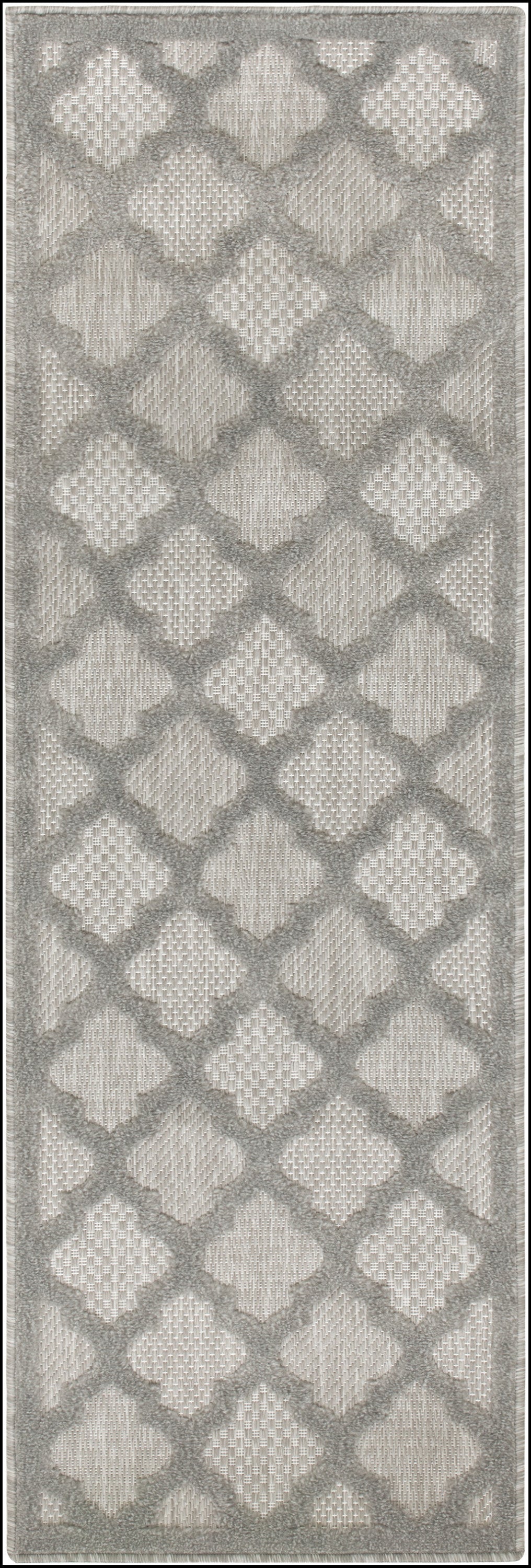 Gray toned outdoor runner rug with an interlocking diamond lattice pattern in beige and a soft fringe border.