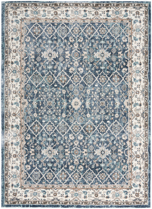 Blue Persian-style area rug with ivory border and intricate floral lattice pattern; vintage distressed look.