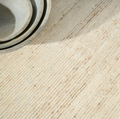 Beige textured rug with light gray-blue tones.