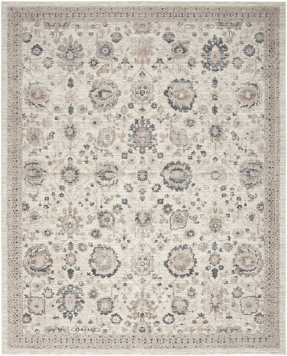 Cream oriental rug with muted blue and beige floral medallions and an ornate border.