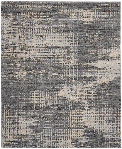 Rectangular abstract area rug in grey and beige with a distressed, brushstroke-like pattern.