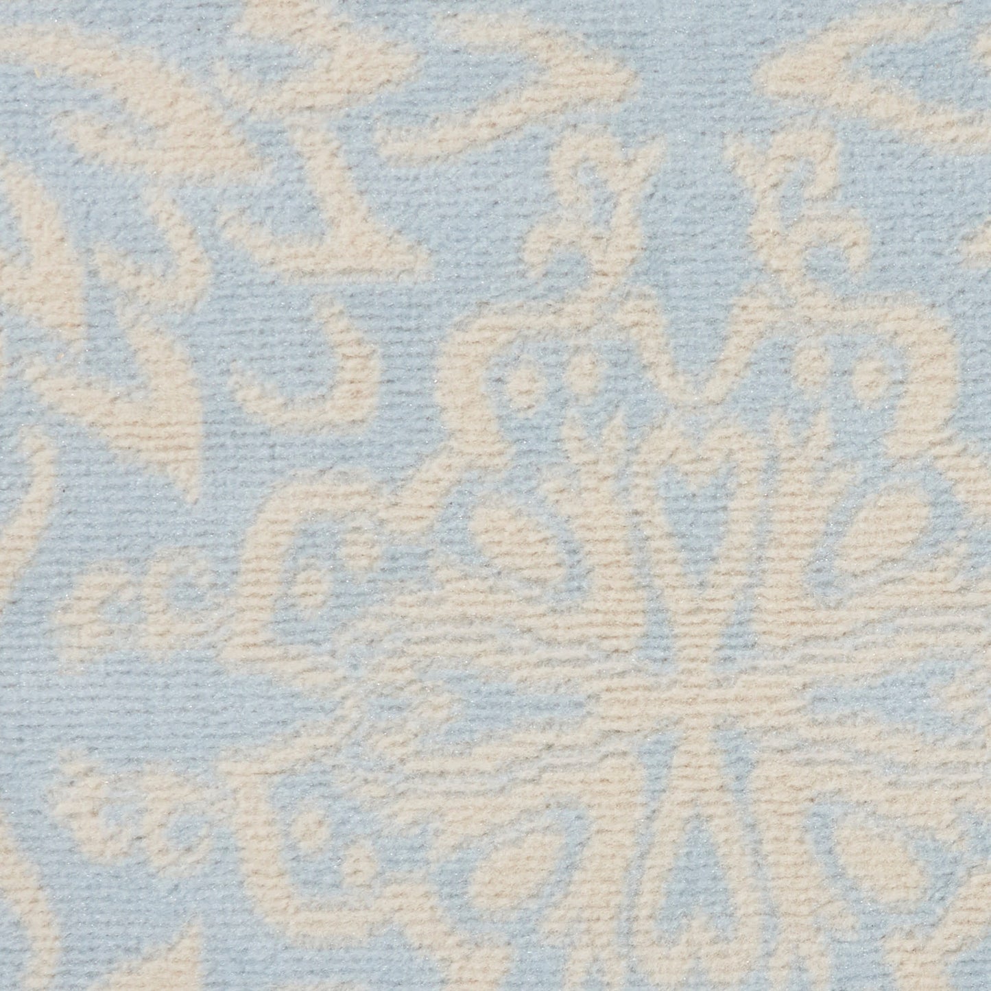 Soft blue textile with ivory damask floral medallion motif in plush woven texture.